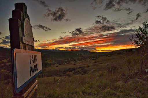 Sunset photo of the Fain Park entrance sign.