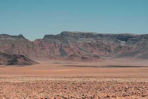 A horizontal shot of mountain landscape at the Namib desert in Namibia under the blue sky