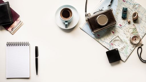 Flat lay with a vintage map with scattered items - the concept of planning a trip or vacation