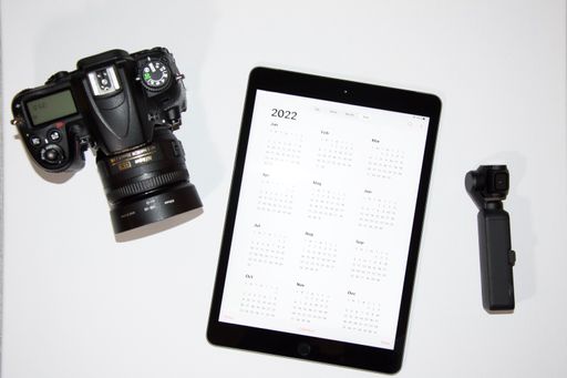 A top view of a camera and a tab displaying calendar