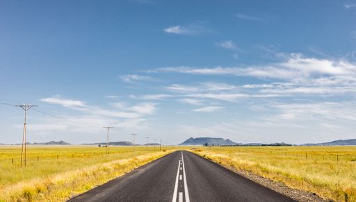 An empty country highway road in the South African farmland region