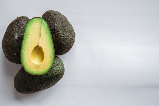 A high angle shot of avocados under the lights isolated on a grey background