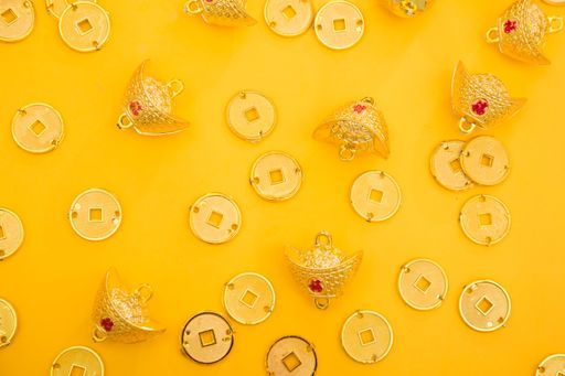 Lunar New Year decoration with lucky gold bar, lucky sacks, and red fish isolated on yellow . Tet Holiday.Translation of text appear in image: fortune