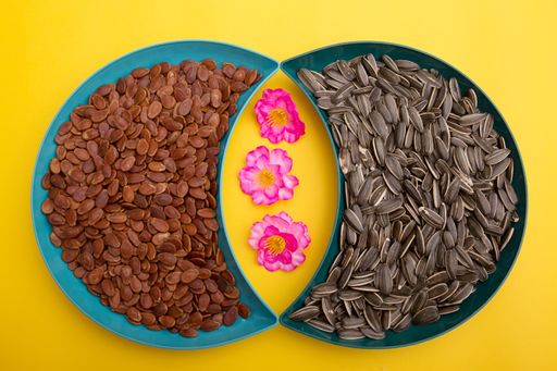 Tet Holiday, Lunar new year, chinese new year concept . Dried sunflower, lotus, watermelon and pumkin seeds top view isolated on yellow