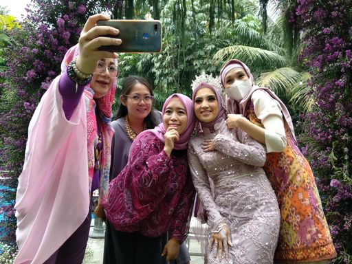 A view of beautiful Muslim females taking selfies on a smartphone in Jakarta, Indonesia