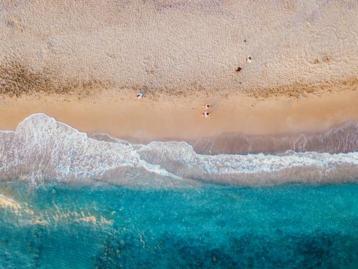 An aerial view of the sandy coast of the turquoise sea