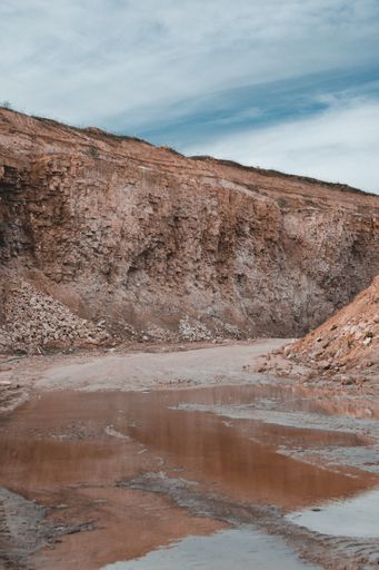 A vertical shot of a brown rock during daytime