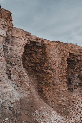 A vertical shot of a brown rock during daytime