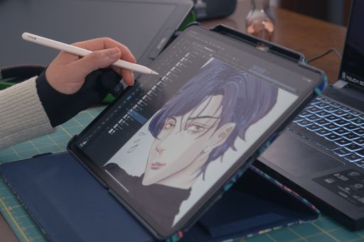 Young asian graphic designer working on computer and drawing digital tablet at office studio. Caserta, Italy, January 02th 2022.