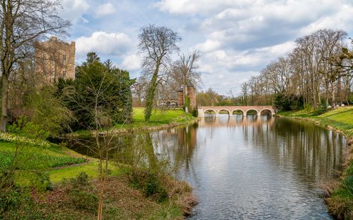 A beautiful view of a bridge over the lake in a park