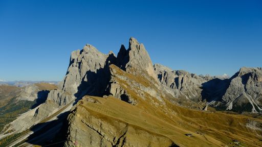 A beautiful view of Seceda mountain peak in bright sunlight against blue sky in Autonomous Province of Bolzano, South Tyrol, Italy
