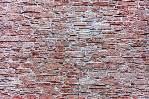 A wall mosaic of red sandstone, granite, and brick texture