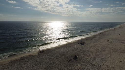 A sea waves on a sandy beach against a cloudy sky in Florida Gulf