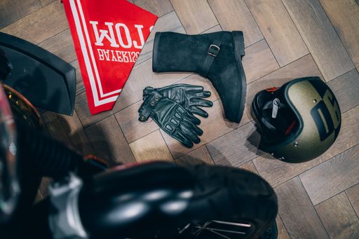 A closeup of gloves, a helmet and other items on the floor