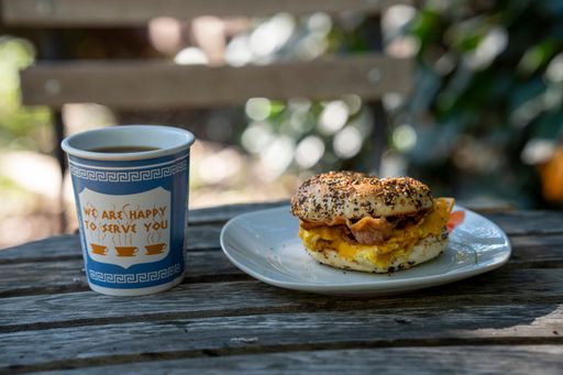 A delicious bagel burger with a cup of coffee