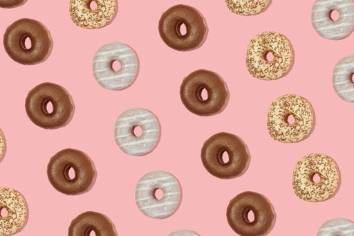 A top view of donuts isolated on powder pink background