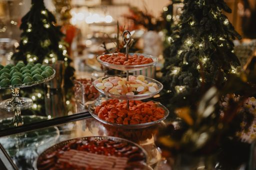 A horizontal shot of a decorated table with plates full of colorful candies and sweets