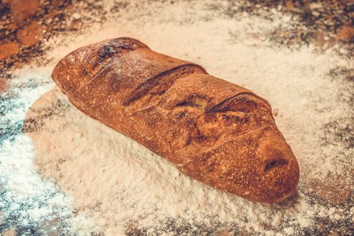 A closeup shot of fresh sourdough bread with walnuts cut into slices