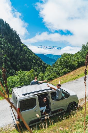 A vertical shot of the friends in the car during a roadtrip in Pyrenees, Spain