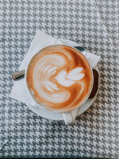 A top view of a cup of latte on the table