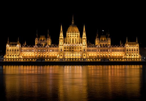Night photo of spectacular hungarian parliamen on bank of Danube river in Budapest. One of the most famous travel and tourist destinations in europe.