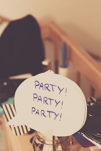 A vertical shot of a sign with a party written on it in a glass jar with a blurred background