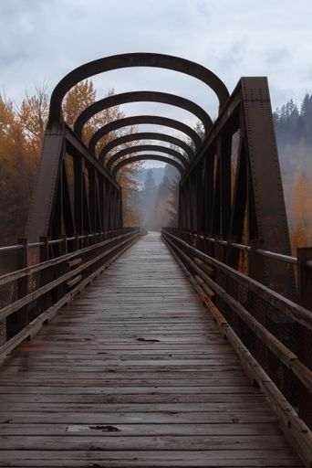 A vertical shot of a wooden bridge in an autumn forest