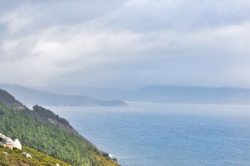 A view of a mountain coast under a cloudy sky