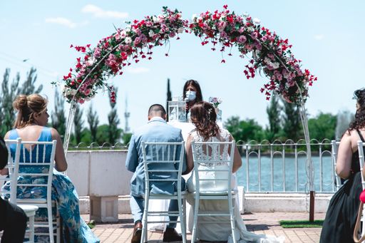 A beautiful shot of a couple being married at an outdoor park during a sunny day
