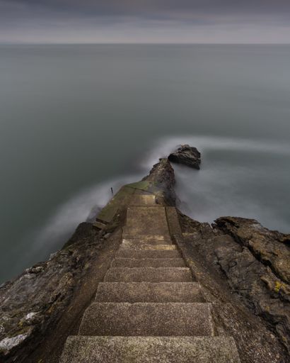 A high angle shot of stairs to the ocean