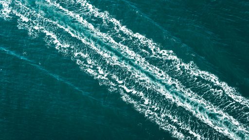 A beautiful shot of a boat trace in the water.