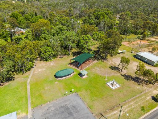 An Aerial View of the town of Gilgai surrounded by green rainforests in Australia