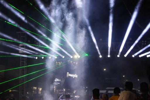 A closeup of people dancing on a laser Light Show in Pune