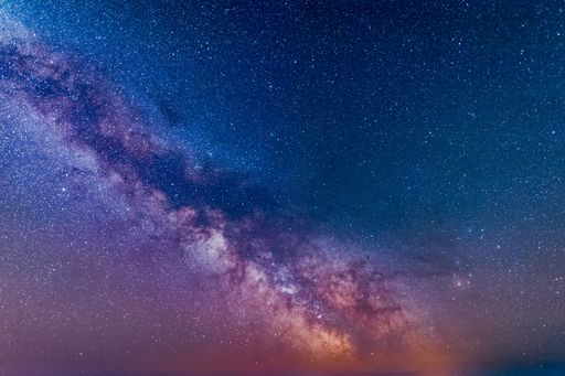 A galactic center of the milky way with many colors on a starry sky in deep space