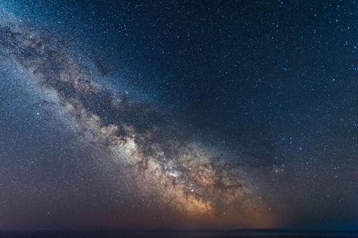A galactic center of the milky way with many colors on a starry sky in deep space