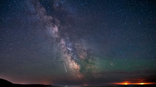 A galactic center of the milky way with many colors on a starry sky in deep space