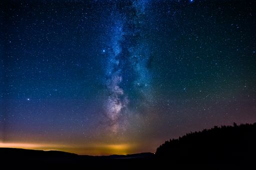 A galactic center of the milky way with many colors on a starry sky in deep space