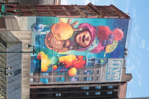 A vertical shot of a graffiti on the side of a building in the heart of Philadelphia