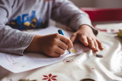 The child drawing with colorful pencils