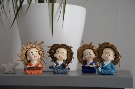 A closeup of small cute monk statues