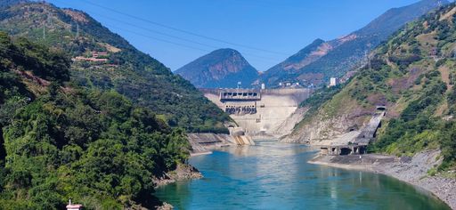 A mesmerizing panoramic view of blue river water between green cliffs on a sunny day