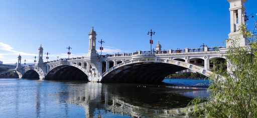 A panoramic view of the Taman Seri Empangan bridge over water on a sunny day in Putrajaya, Malaysia
