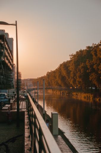A vertical shot of a bridge over the river at daylight