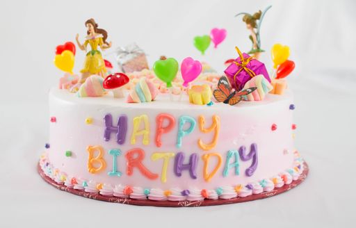 A beautifully decorated birthday cake with candies and marshmallows