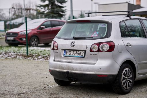 A parked dirty grey Volkswagen Golf Plus car on a cold winter day.