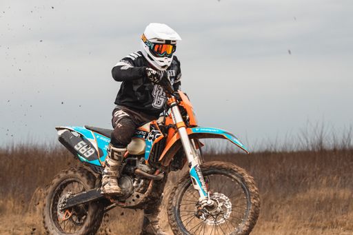 A man in a protective suit riding a motocross