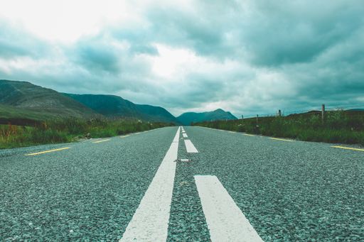 A low angle shot of the road to the mountains in Ireland