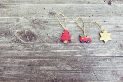 A high angle shot of cute Christmas tree ornaments on a wooden surface at daytime