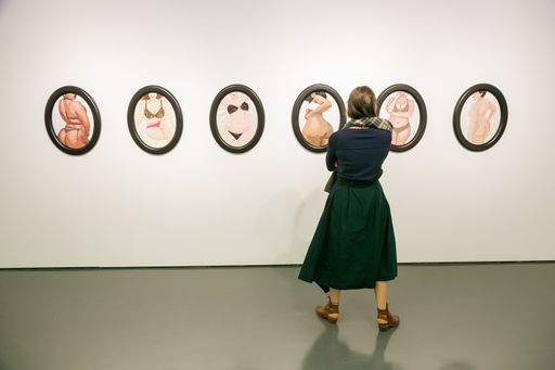 Johannesburg, South Africa - September 5, 2018: A female visitor viewing art exhibit in a gallery