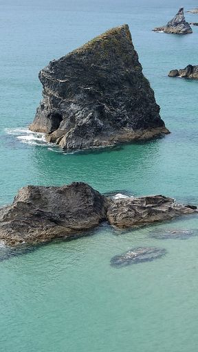 The sea stacks and a clear blue sea during daytime